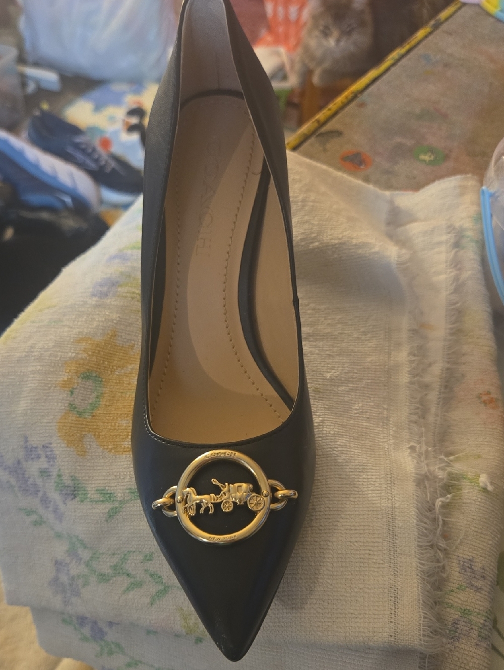 Coach Black Pointed Toe Pump with Gold Carriage Medallion